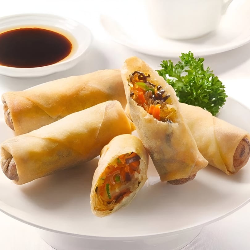 Crispy Korean spring rolls with vegetable filling, served with a side of soy sauce and parsley.
